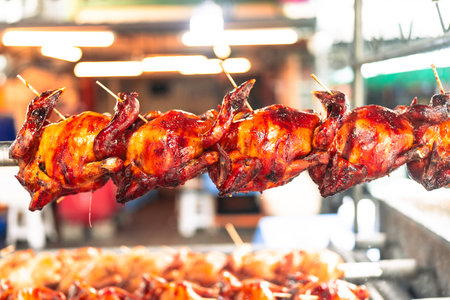 Appetizing toasted chicken in charcoal grills. Selective focusの写真素材