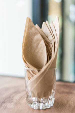 Brown Tissue paper in glass on the table at a cafeの写真素材