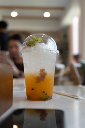 Glass of iced passion fruit soda, refreshing drink or beverage with iceの写真素材