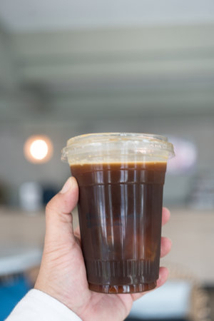 Iced black coffee, also known as iced Americano on handの写真素材