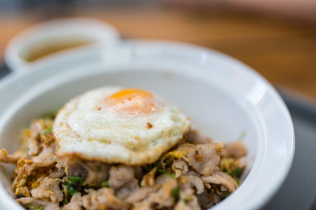 Close up of steam pork on rice and fried eggの写真素材