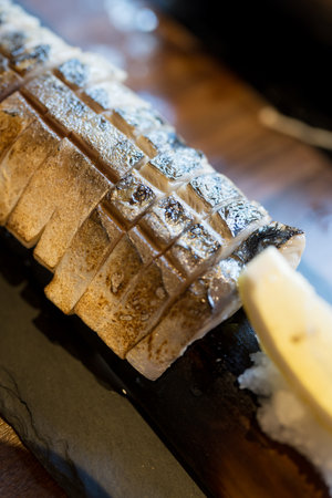 Grilled saba fish with soy sauce and salt with lemon slice. Close upの写真素材