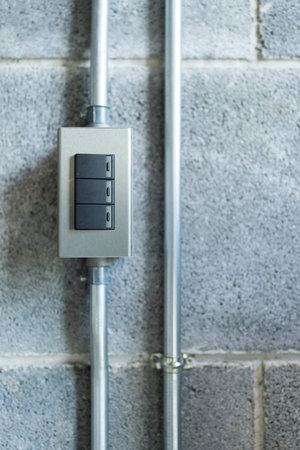 Close up of light switches attached on wallの写真素材