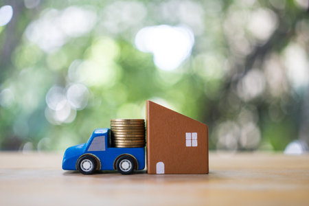 Real estate investment concept, wooden home, car with stack of money coins. Property mortgage, financial or insurance house, essentials for life ideas. Concept of plan investment buy sell car ensuring idea.の写真素材