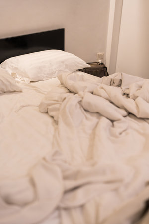 A rumpled bedding suggesting recent use in the morningの写真素材