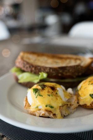 Egg benedict on a plate. Featuring poached eggs and hollandaise sauce. Selective focusの写真素材
