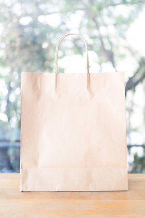 Neatly arranged brown paper shopping bags on table displayの写真素材