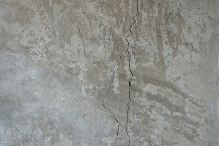 Dirty concrete cement white grey wall grunge rough crack surface damage. Old cracked wallの写真素材