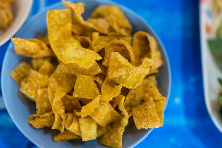Fried crispy wonton strips in a bowl, free service at noodle restaurants, appetizersの写真素材