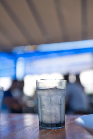 Sphere glass with ice cubes and water on table. Close upの写真素材