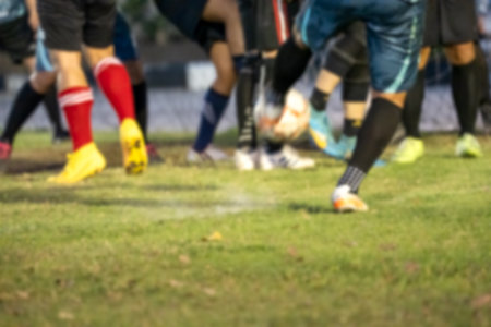 Close up of foot football players on the grassy fieldの写真素材