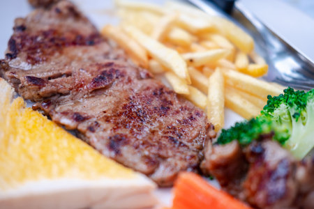 Grilled beefsteak with french fries and mixed vegetables. Selective focusの写真素材