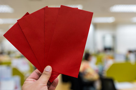 Man holding a red envelope, greetings or warnings.の写真素材
