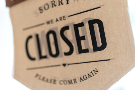 A sign hanging off coffee shop door. Close sign blur background. Label word closeの写真素材