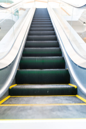 Elevator escalator is moving staircase used as transportation between floors or levels building