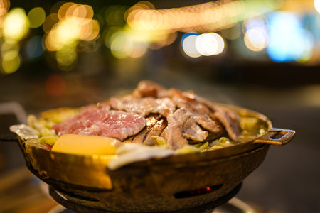 Pork dishes grill barbecue with pork on hot pan at night.
