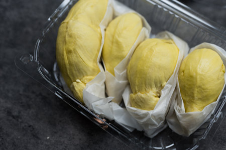 Freshly packed durians in a clear plastic box
