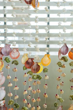Variety of handcrafted seashell mobiles hanging as decorative coastal home accents, seashell mobileの写真素材