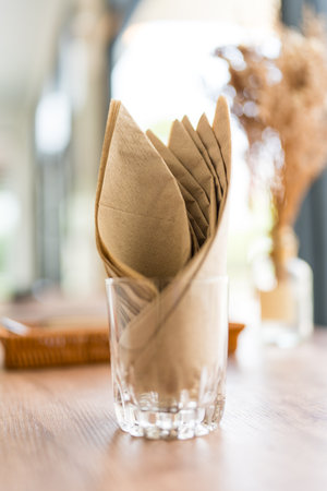 Brown tissue paper in glass on tableの写真素材