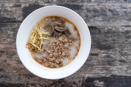 Rice porridge pork on white bowl put on wood tableの写真素材