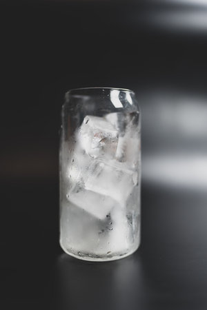 A glass filled with homemade ice cubes, prepare for cool beverageの写真素材