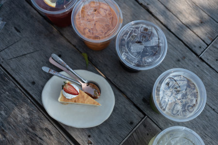 Cake strawberry served with many cool drink on wood tableの写真素材