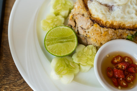 Close up of chilli with fish sauce, slice cucumber, lemon in fried rice mealの写真素材