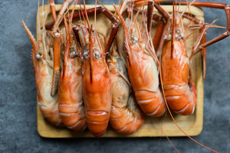 Many big steamed prawns served on wood tray, shrimp completed so delicious, Thai food