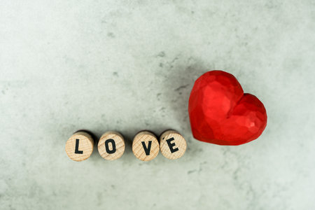 Text of LOVE with wood red hearts. Perfect for Valentine's or any affection celebration.の写真素材