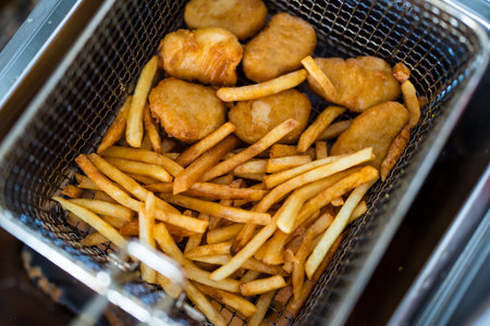 Crispy chicken nuggets with french fries after cooking. Close upの写真素材