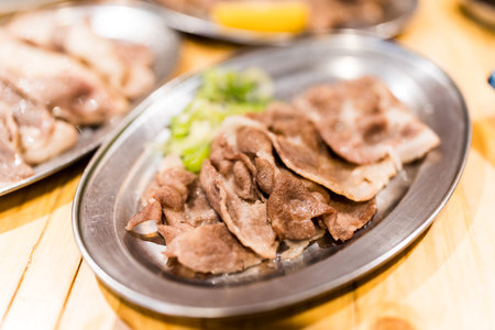 Grilled beef tongue slices,  creating flavorful and appetizing presentationの写真素材