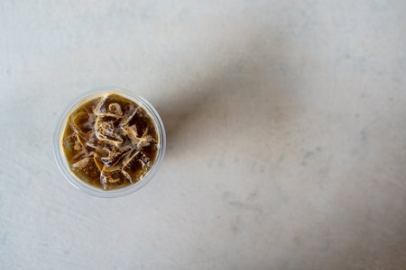Overhead view shot of iced Americano in plastic cup.の写真素材