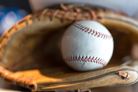 Baseball glove with a ball inside, sport equipment for baseball game, training and recreationの写真素材