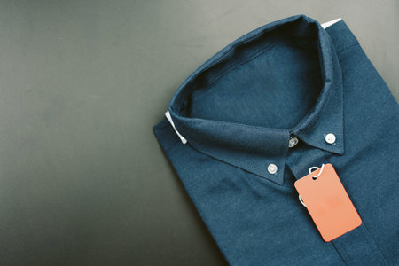 Dark blue folded long sleeve men shirt with a red paper tag