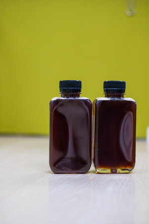 Two Iced cold brew coffee with black lid on table