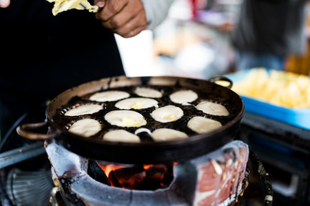 Khanom Khai in hot pan make by Thai trader, Khanom Khai is a Thai oval sweetmeat made with egg and sugarの写真素材