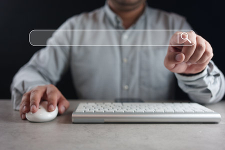 Data Search Technology. Man hand tapping on virtual search bar while using laptop, show search for...
