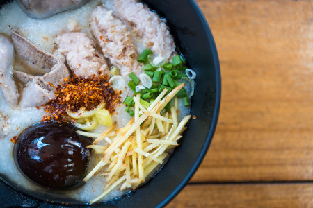 Thai style bowl of congee served for breakfast. Thai food breakfast