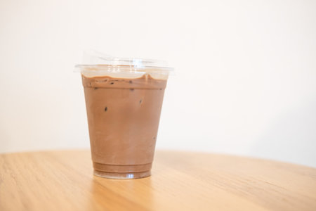 Iced coffee Mocha in plastic cup put on desk at coffee shop