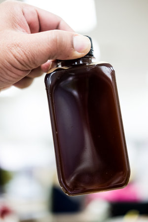 Ice Americano in a plastic bottle. Drinks for a relaxing afternoon at the office in hand.の写真素材