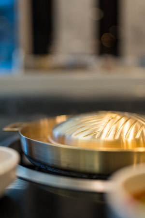 Brass pan use electricity for BBQ grill. Selective focus