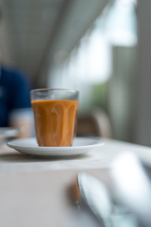 Traditional Thai hot milk tea served in an Asian style glassの写真素材