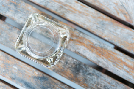 A glass ashtray upside down on a wooden table