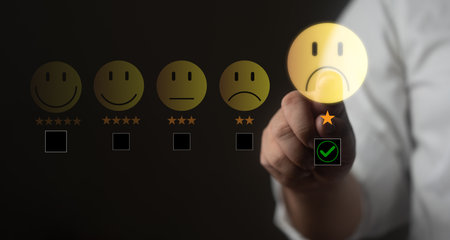 Man pressing unhappy customer feedback icon, concept of poor service review, dissatisfaction, and negative experience. Satisfaction ratingの写真素材