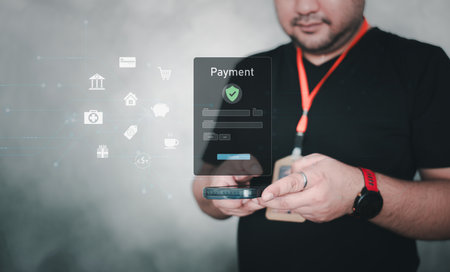 An officer uses mobile payment authentication on a laptop for secure online shopping transaction, completing digital banking with smartphone verification and account protection.の写真素材