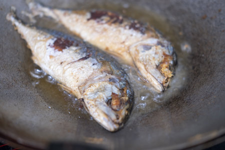 Mackerel frying, Fried mackerel on pan. Close upの写真素材