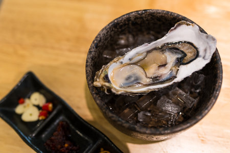Close up fresh oyster served on ice in bowlの写真素材