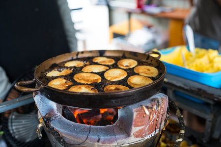Khanom Khai in hot pan. A Thai oval sweetmeat made with egg and sugarの写真素材