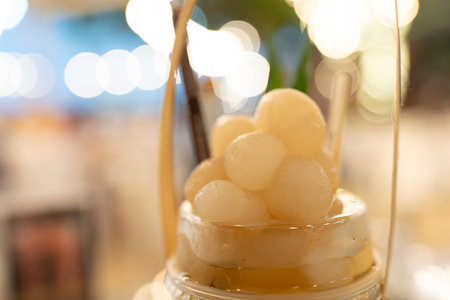 Iced longan juice with whole longan fruits on top.の写真素材