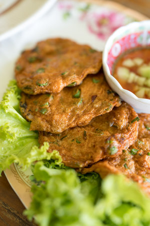 Thai spicy fish cake, tod mun served together with sweet sauce with cucumber slices.の写真素材